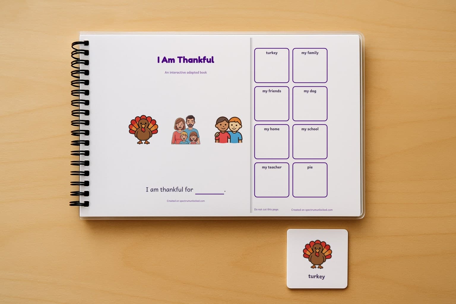 The I Am Thankful adapted book closed on a table, its cover facing up, one picture card beside it
