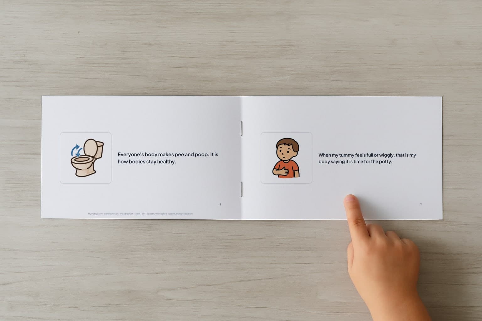 The Using the Potty social story booklet open to its first two pages, a child's finger pointing at the picture