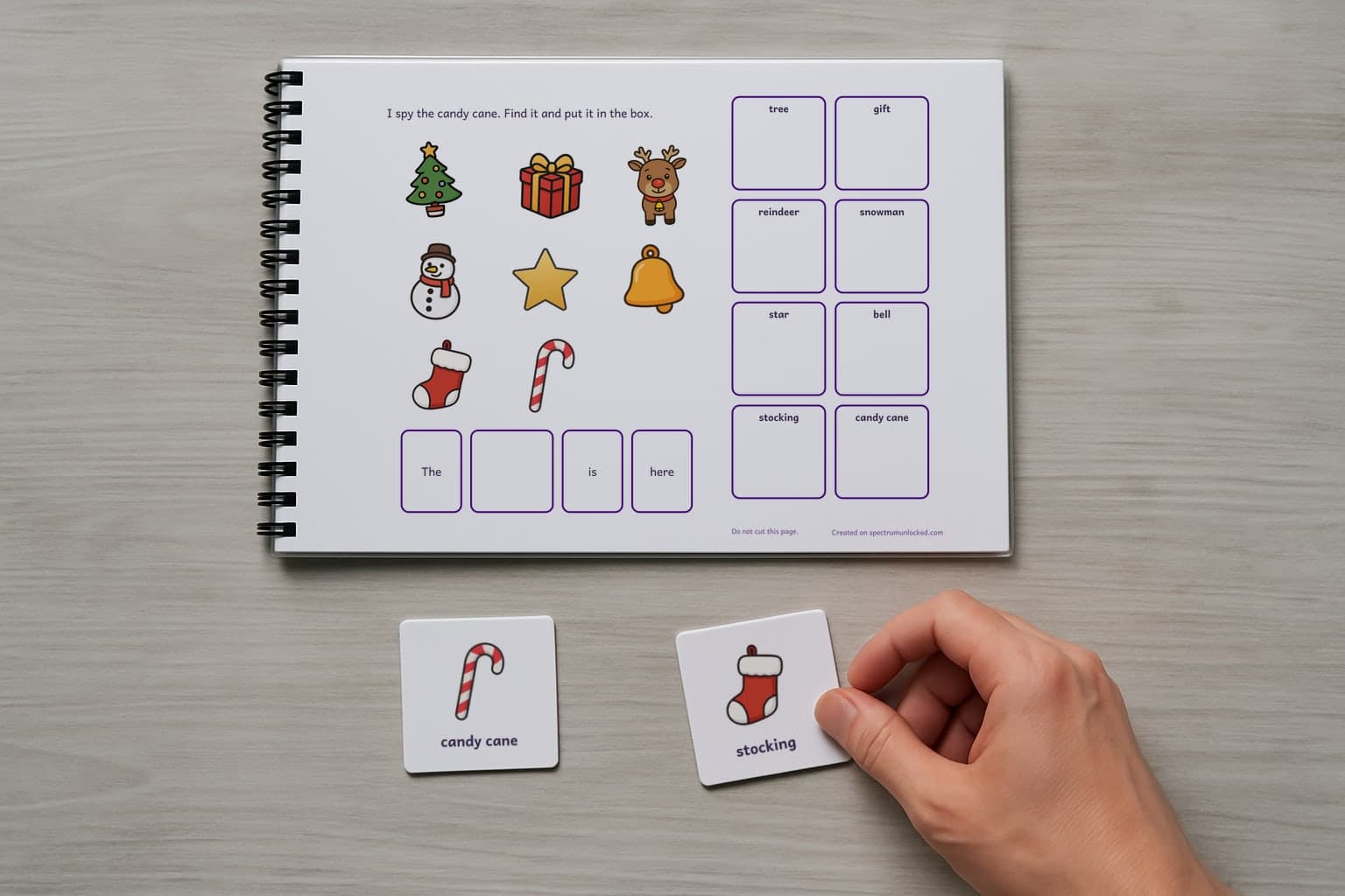 The last page of the I Spy Christmas adapted book with its choice column, two picture cards resting beside it