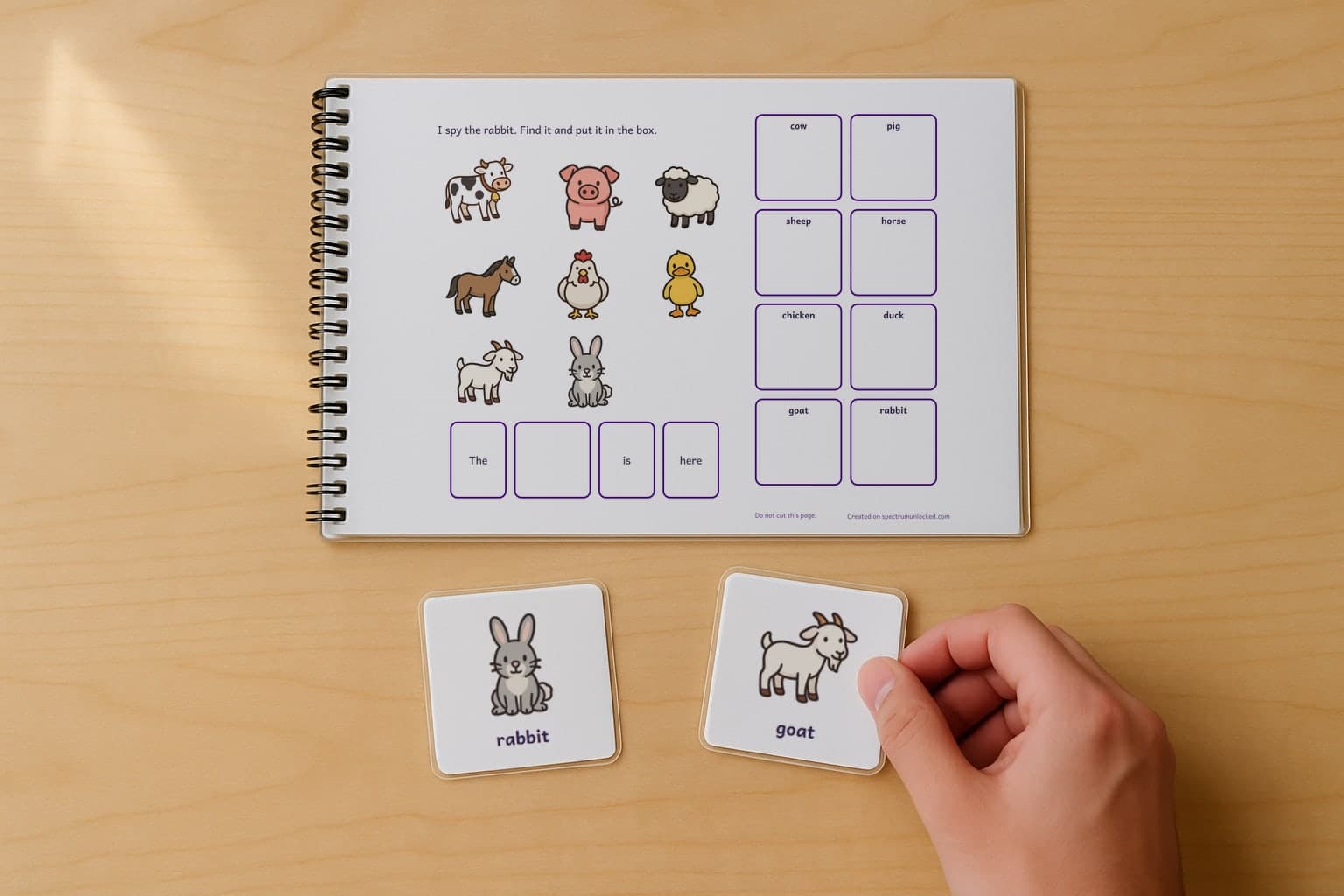 The last page of the I Spy Farm Animals adapted book with its choice column, two picture cards resting beside it