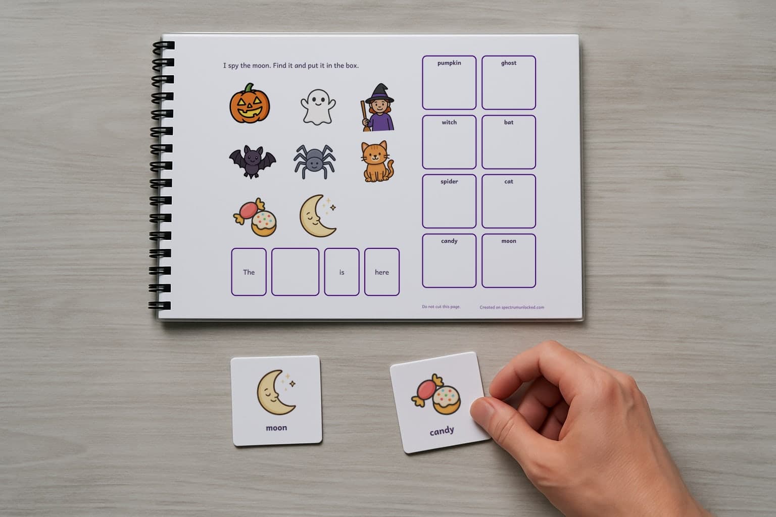 The last page of the I Spy Halloween adapted book with its choice column, two picture cards resting beside it