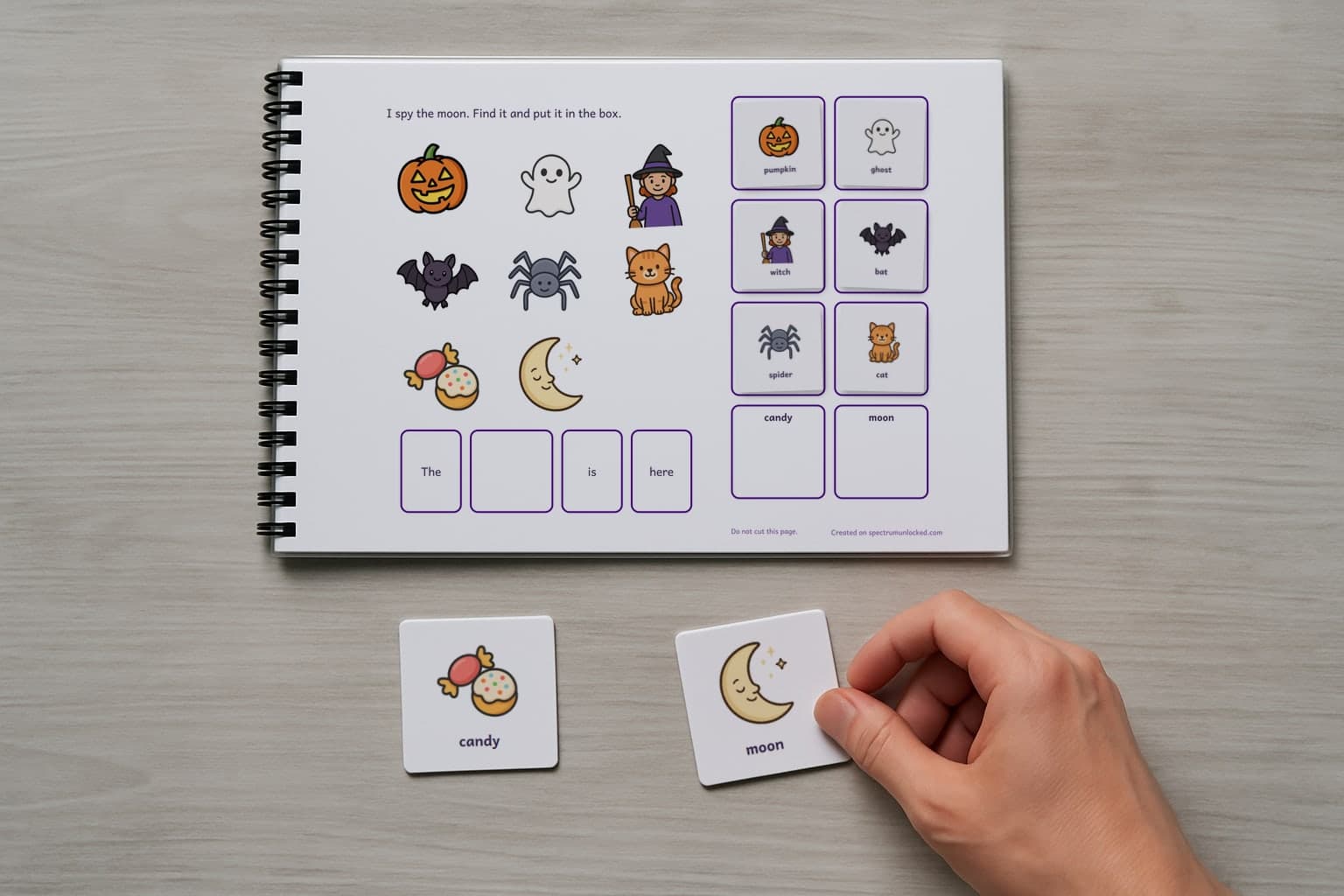The I Spy Halloween adapted book with its picture cards stored on the choice column, the last two loose on the table