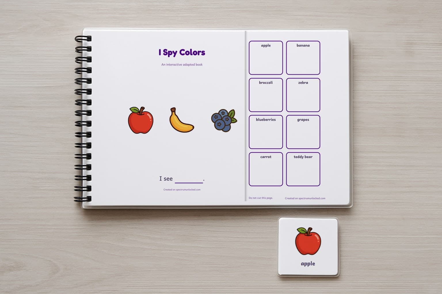 The I Spy Colors adapted book closed on a table, its cover facing up, one picture card beside it