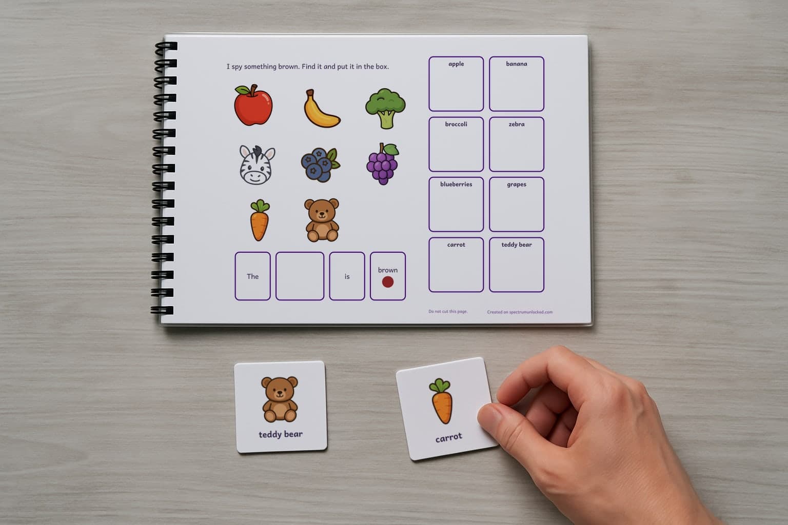 The last page of the I Spy Colors adapted book with its choice column, two picture cards resting beside it