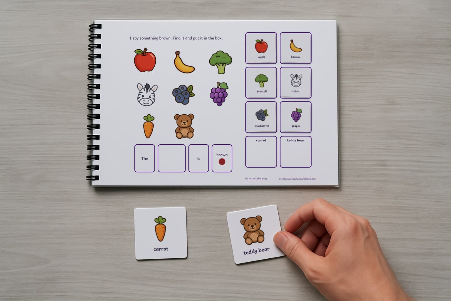 The I Spy Colors adapted book with its picture cards stored on the choice column, the last two loose on the table