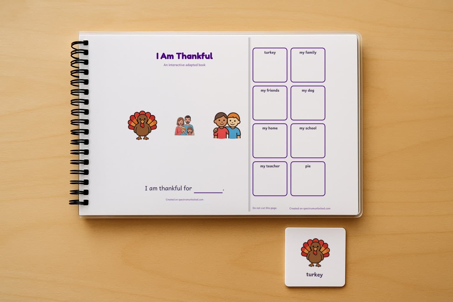 The I Am Thankful adapted book closed on a table, its cover facing up, one picture card beside it