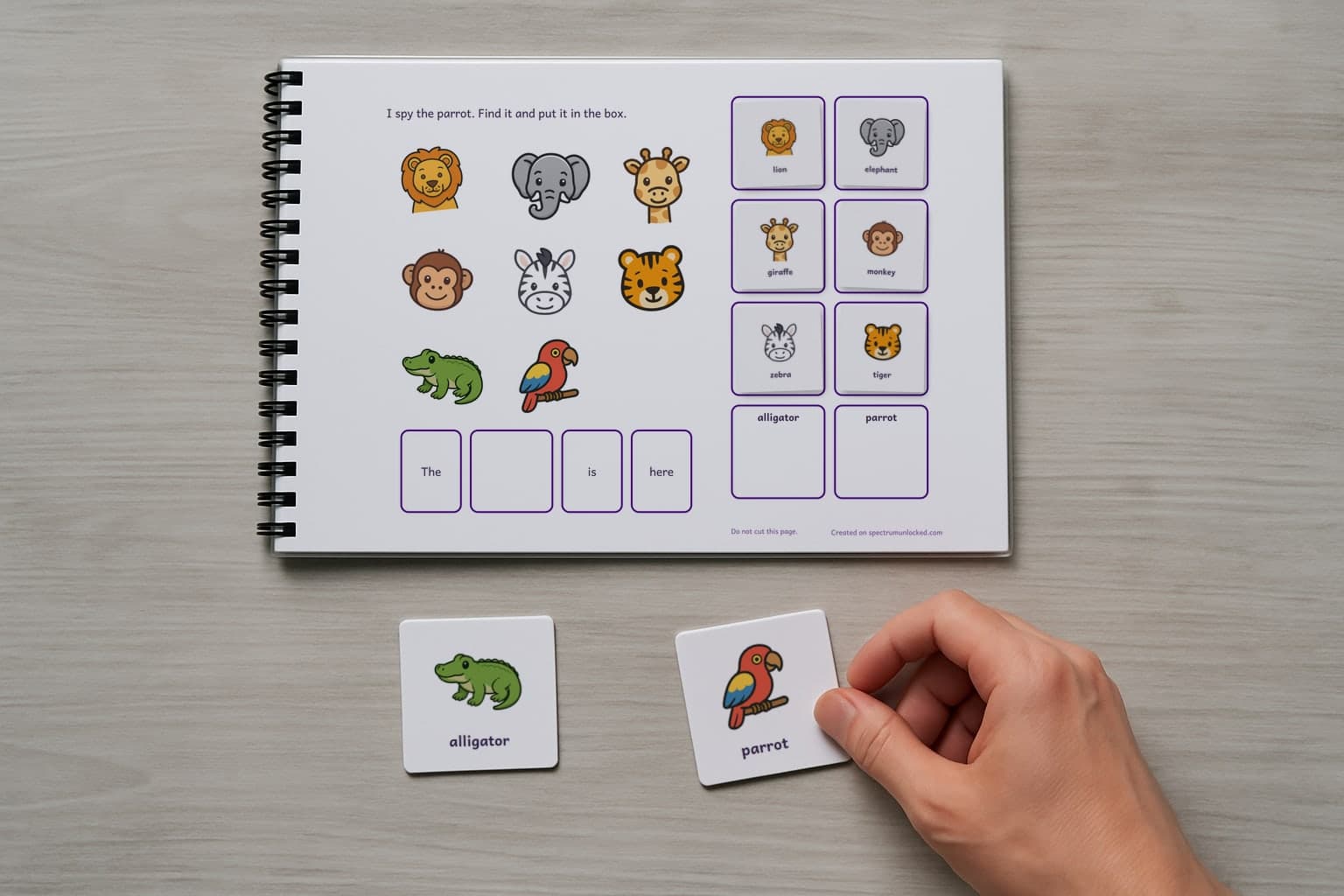 The I Spy Zoo Animals adapted book with its picture cards stored on the choice column, the last two loose on the table