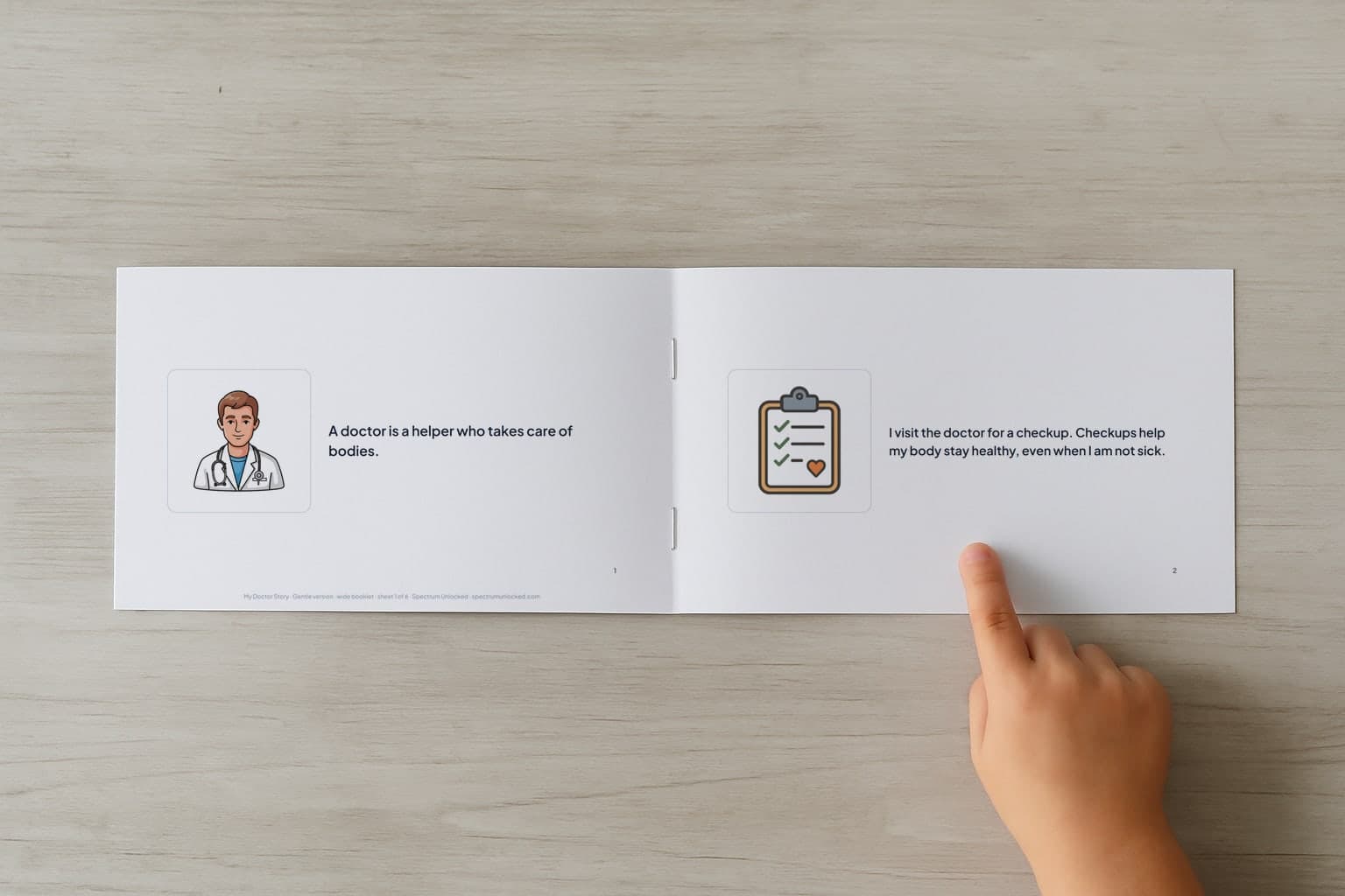 The Going to the Doctor social story booklet open to its first two pages, a child's finger pointing at the picture