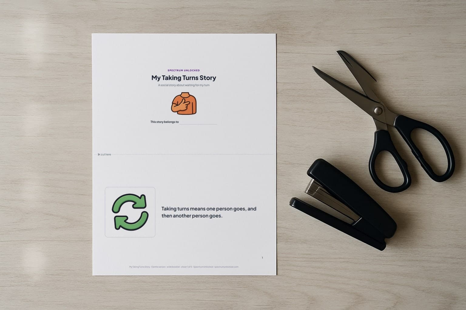 The Taking Turns social story printed two pages to a Letter sheet, scissors and a stapler beside it before the cut